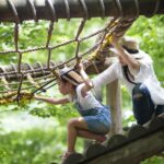 family playing on rope course